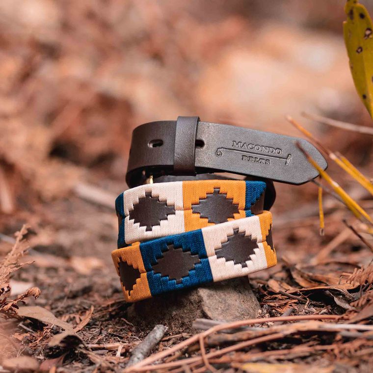 Two woven belts on autumn ground